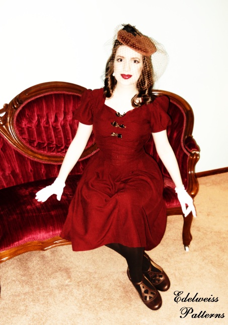 vintage girl wearing red 1940s sweetheart dress and vintage hat