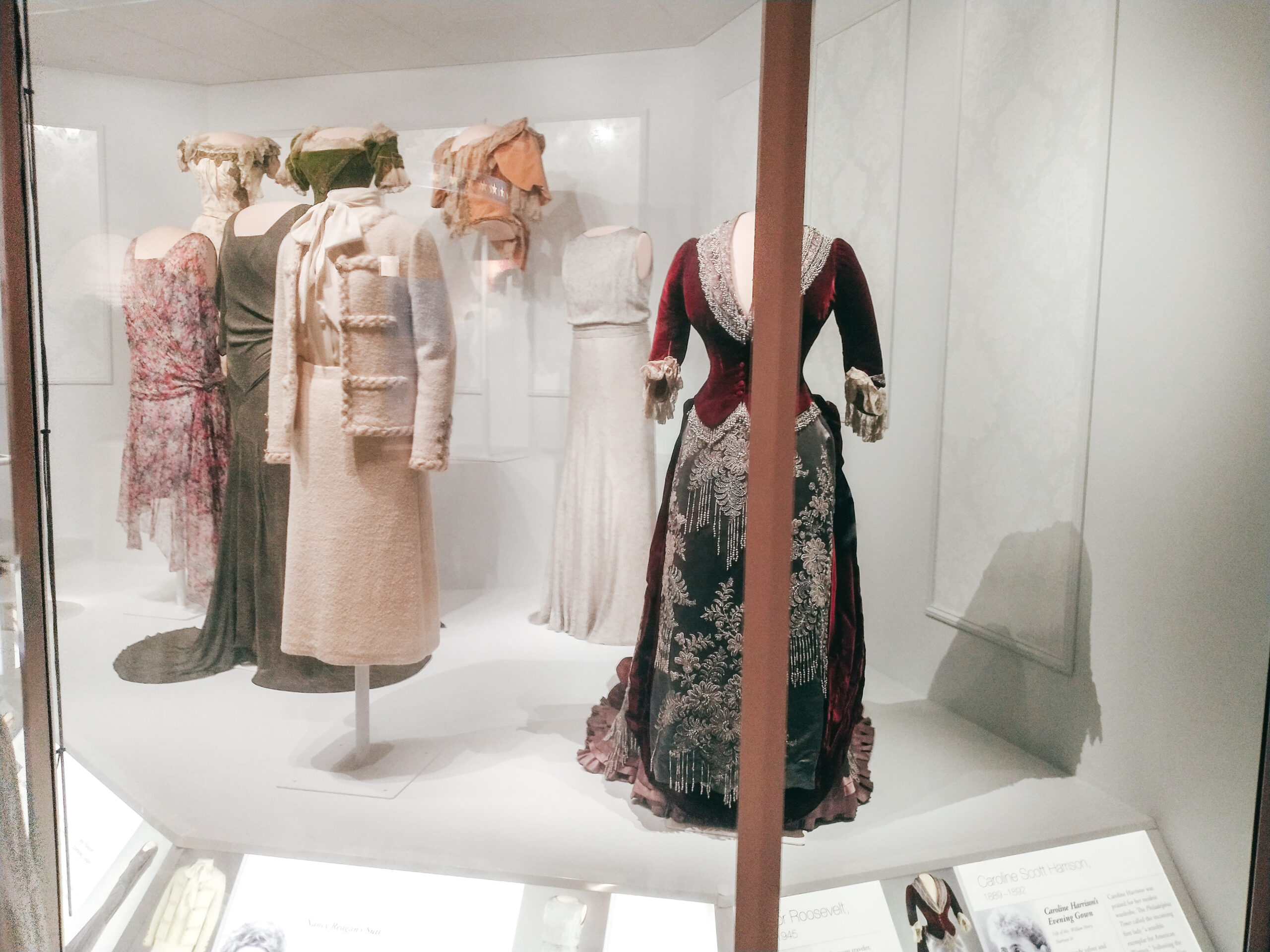 First Ladies' gowns on mannqeuins behind glass in a musem