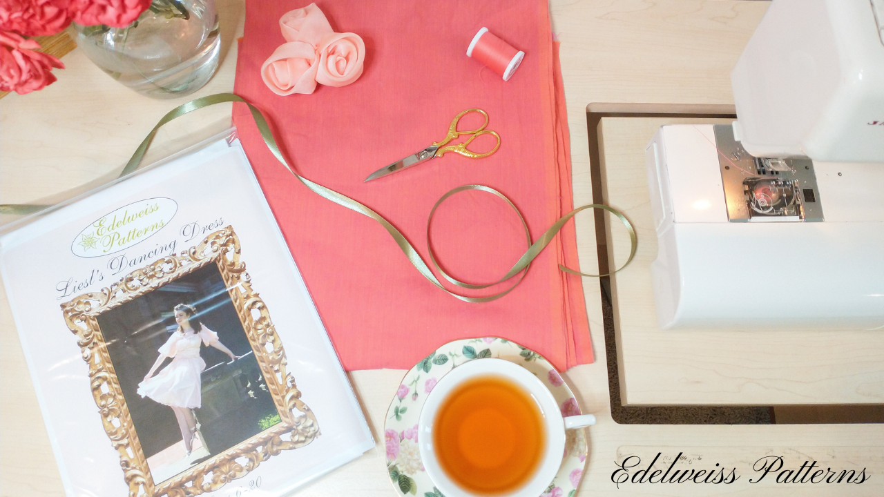 fabric with pattern and teacup at sewing machine