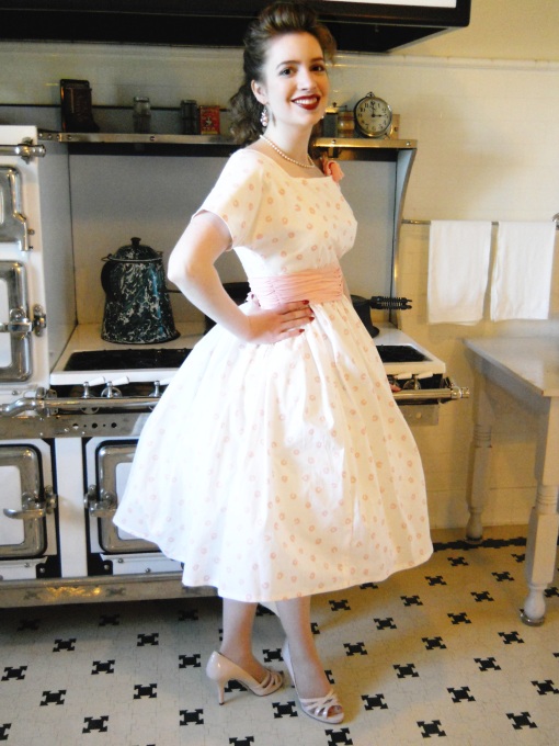 girl wearing 1950s dress in a retro kitchen